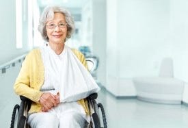 Lady in wheelchair with sling on arm